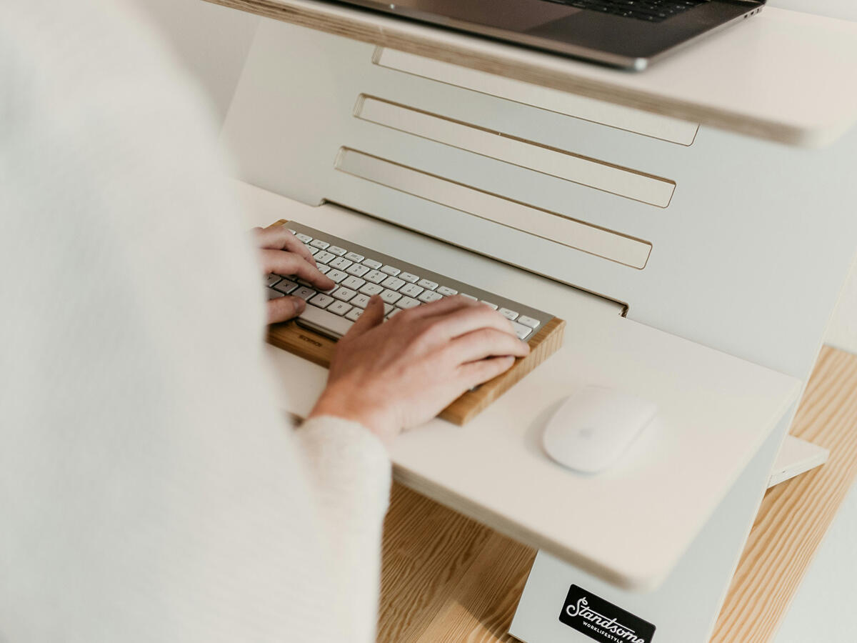 A high-resolution display showing clinical data and medical AI models on a modern laptop, representing the sophisticated remote work of an AI Nurse Subject Matter Expert.